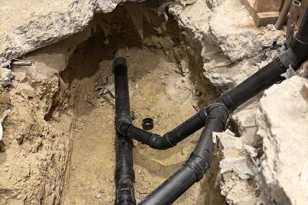 Replacement drain lines set in the under-slab excavation