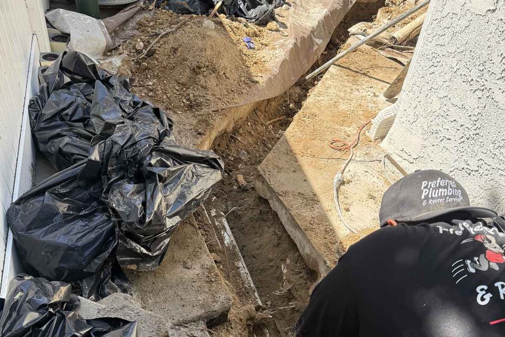 Preferred Plumbing technician digging out a sewer line
