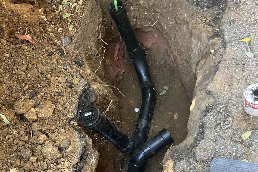 Cleanout and sewer fittings installed in an open pit