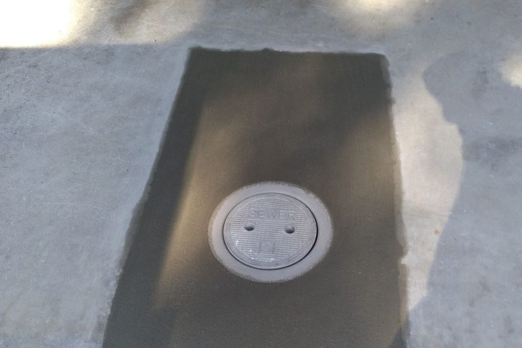 Cleanout cap set into a new concrete patch