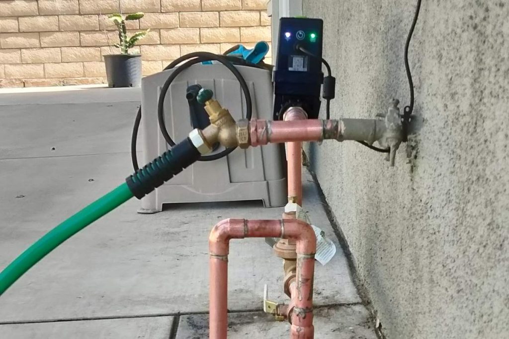 Copper riser and hose bib set at the house wall