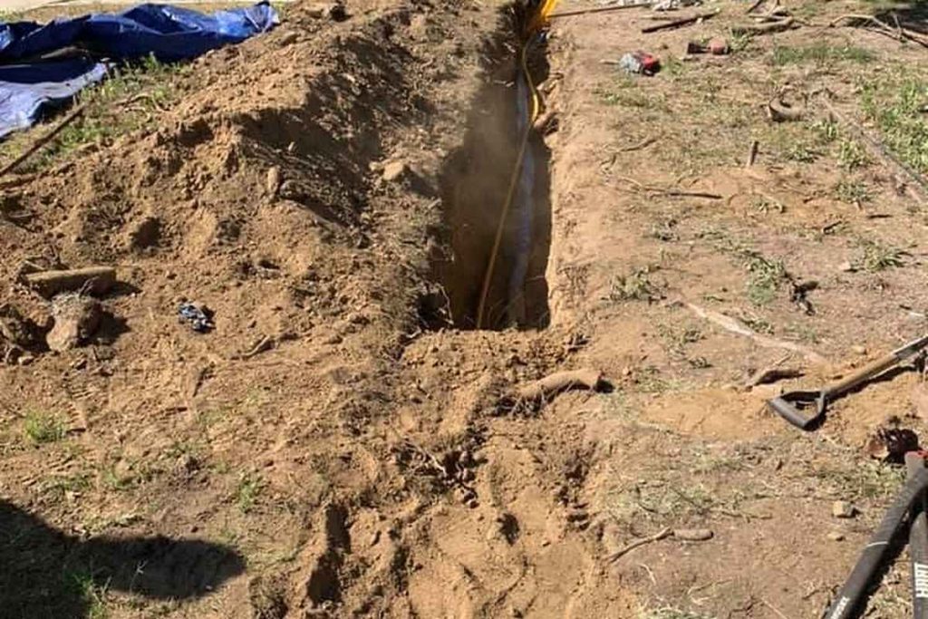 Sewer trench with the spoil pile and cleanout box