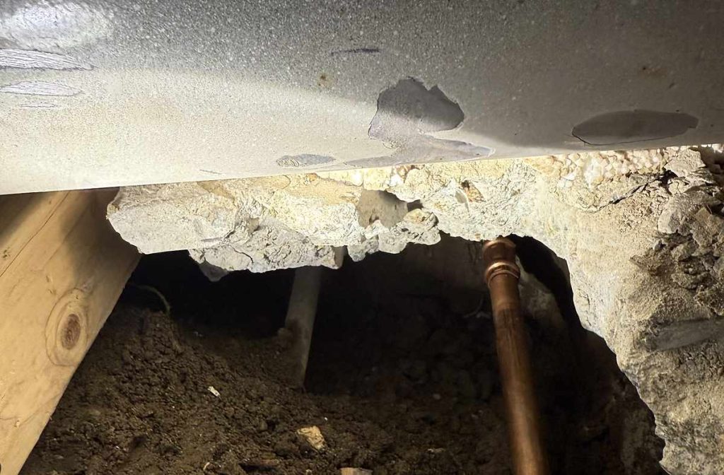 Under-slab excavation opened to reach a leaking line