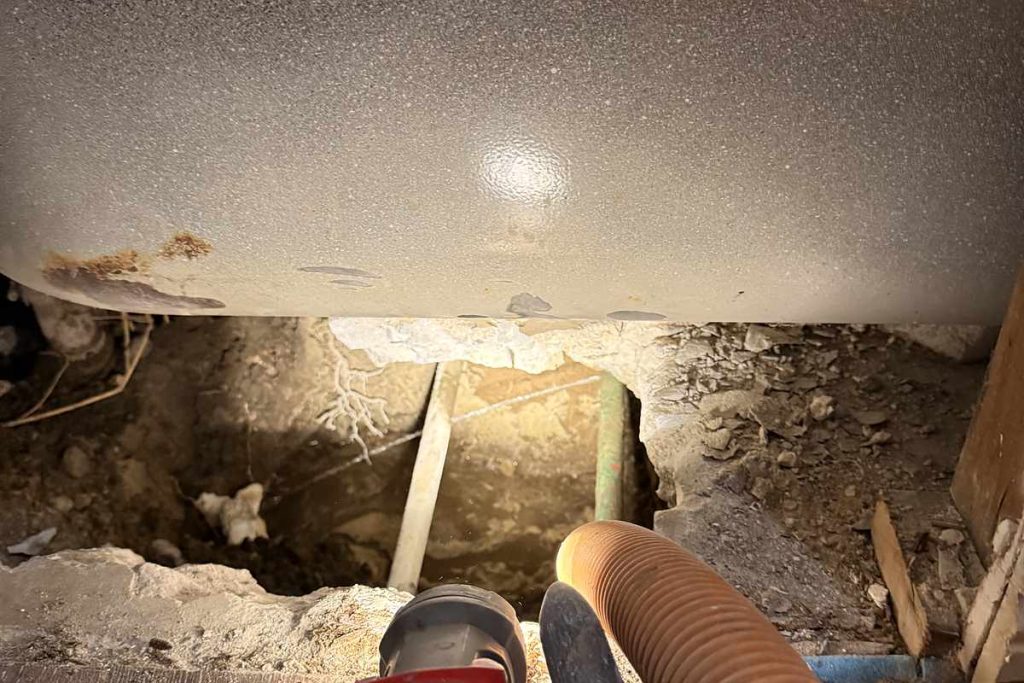 Excavation under a cabinet during a slab leak repair