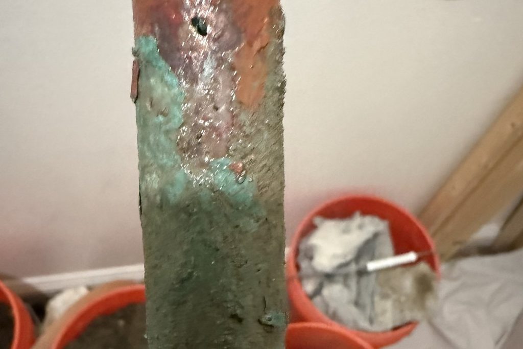 Pinhole corrosion on a copper line taken out of a slab