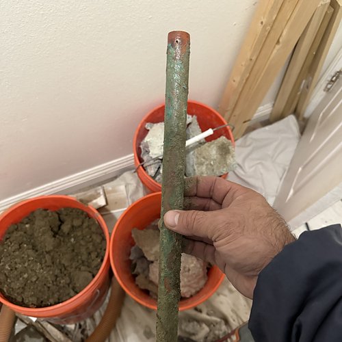 Corroded copper pipe removed from under a slab
