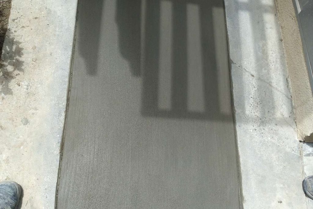 Curved concrete patch finished after an excavation