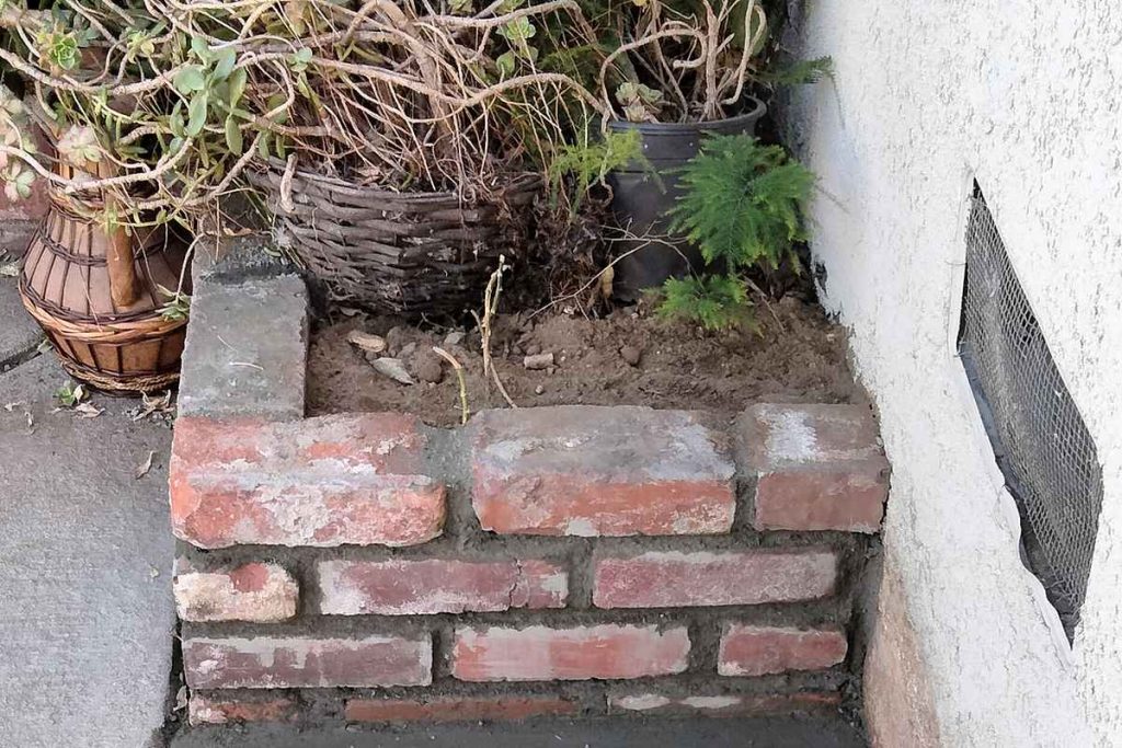 Concrete patch and cleanout in a narrow side yard