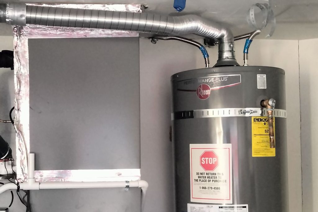 Water heater and new vent piping in a utility closet