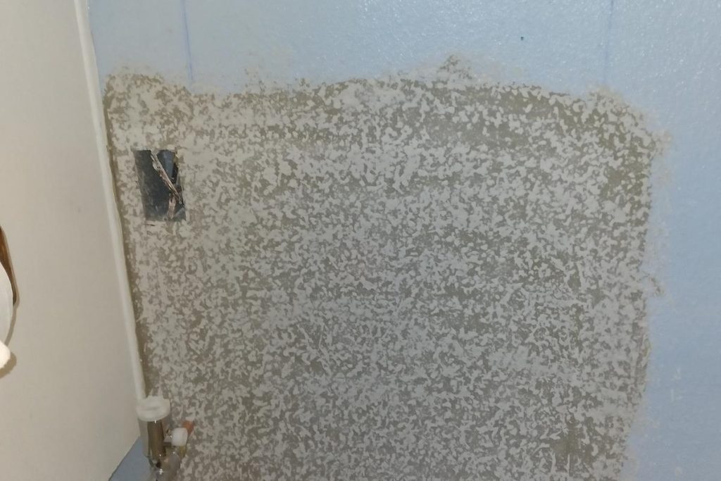 Bathroom wall patched after a leak repair