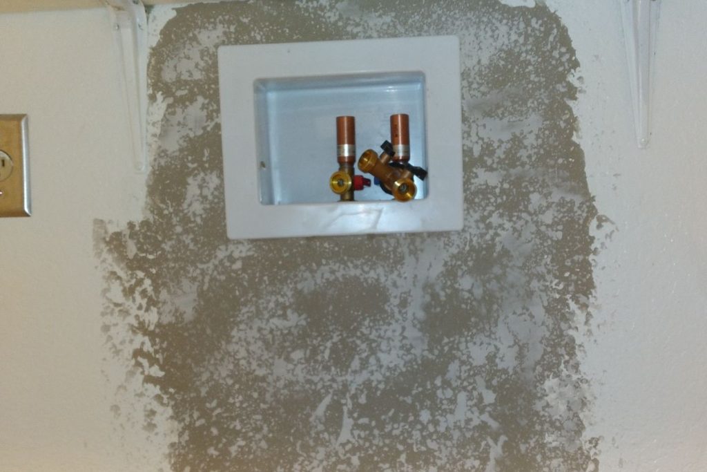 Washer box reset into a patched wall