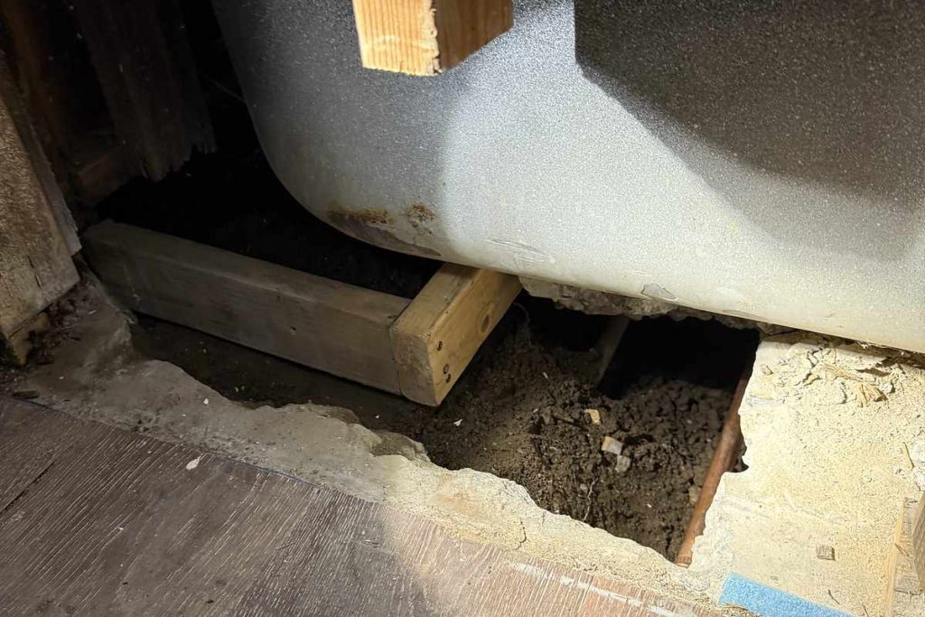 Tub removed to reach the leaking drain below