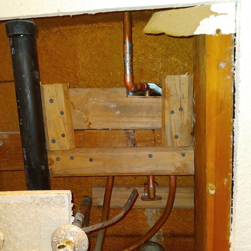 Floor and wall opened to replace copper and drain lines