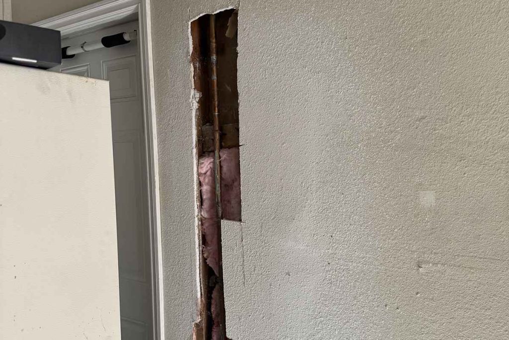 Interior wall access opened for new water lines