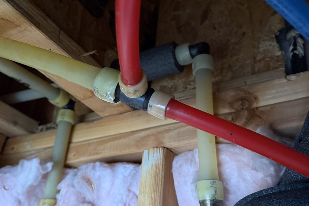 Colour-coded PEX repipe lines routed overhead