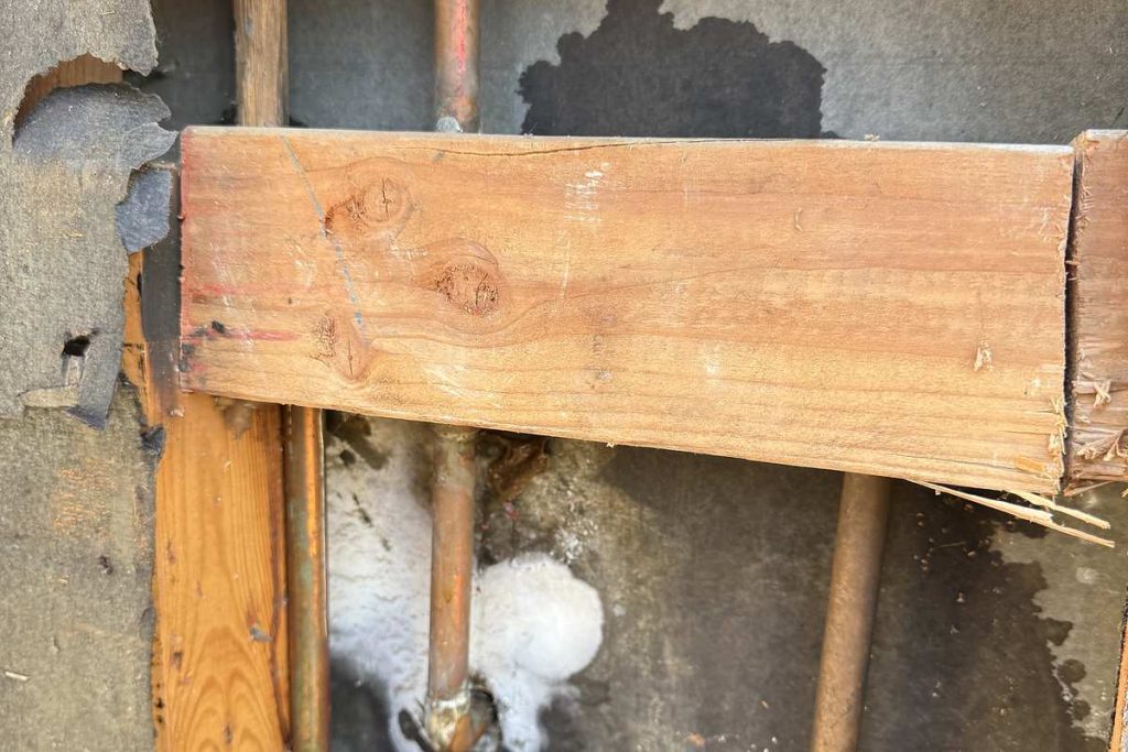 Exterior siding opened to run new copper supply lines