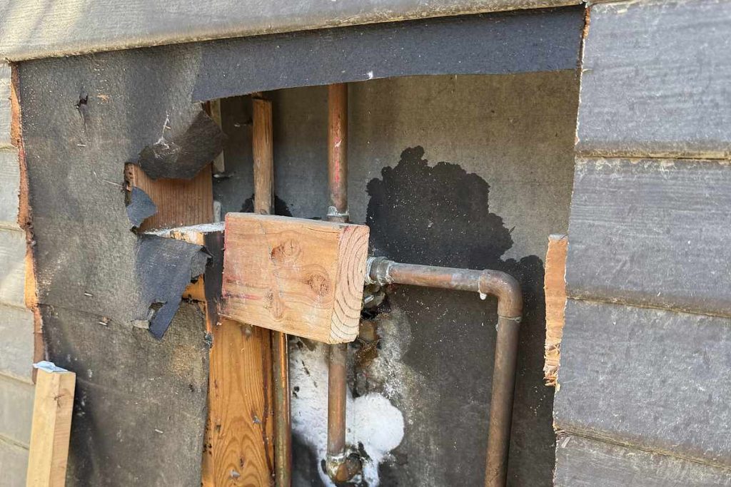 New copper piping installed behind the exterior wall