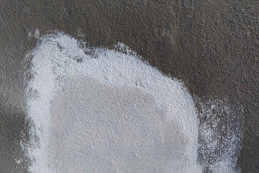 Concrete floor patched over a repaired line