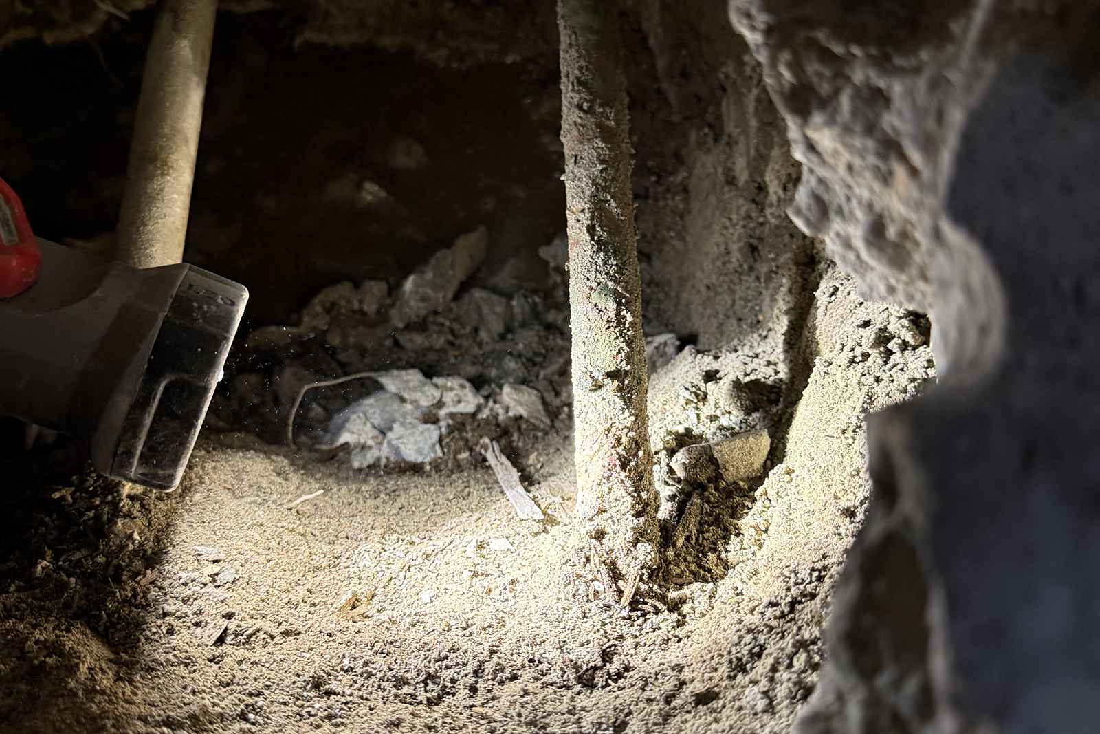Tunnel dug beneath a foundation footing to reach a leak