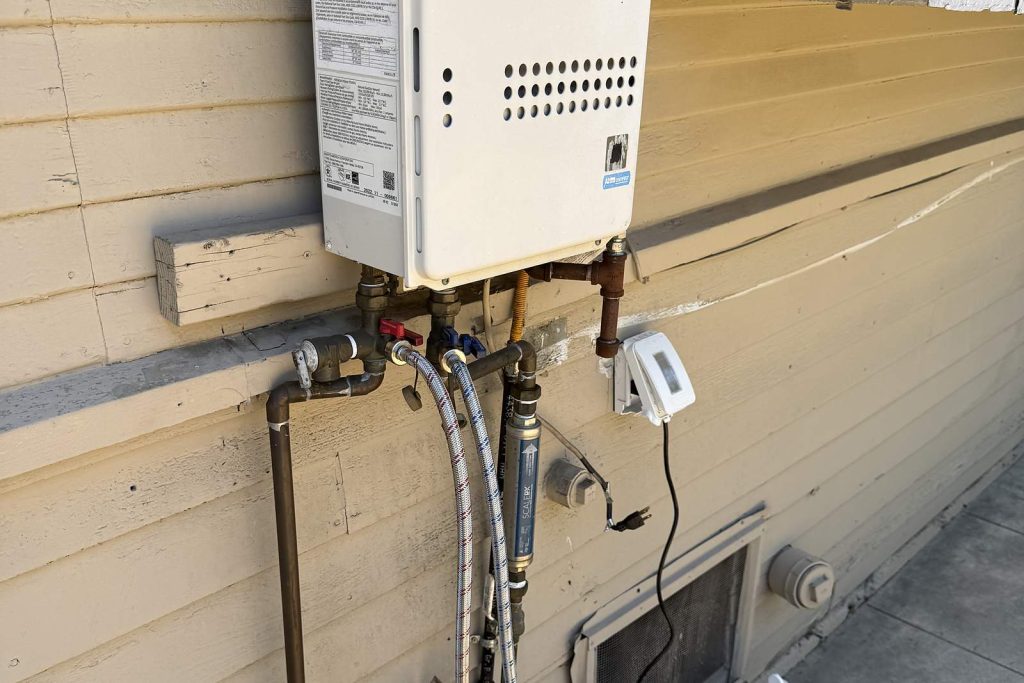 Noritz tankless water heater mounted on an exterior wall