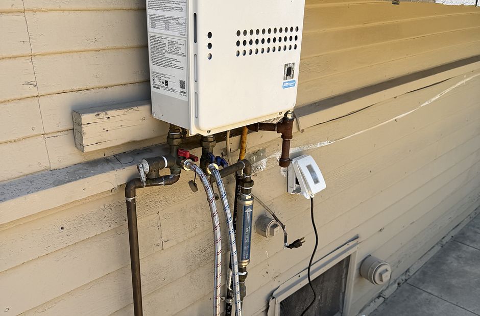 Noritz tankless water heater mounted on an exterior wall