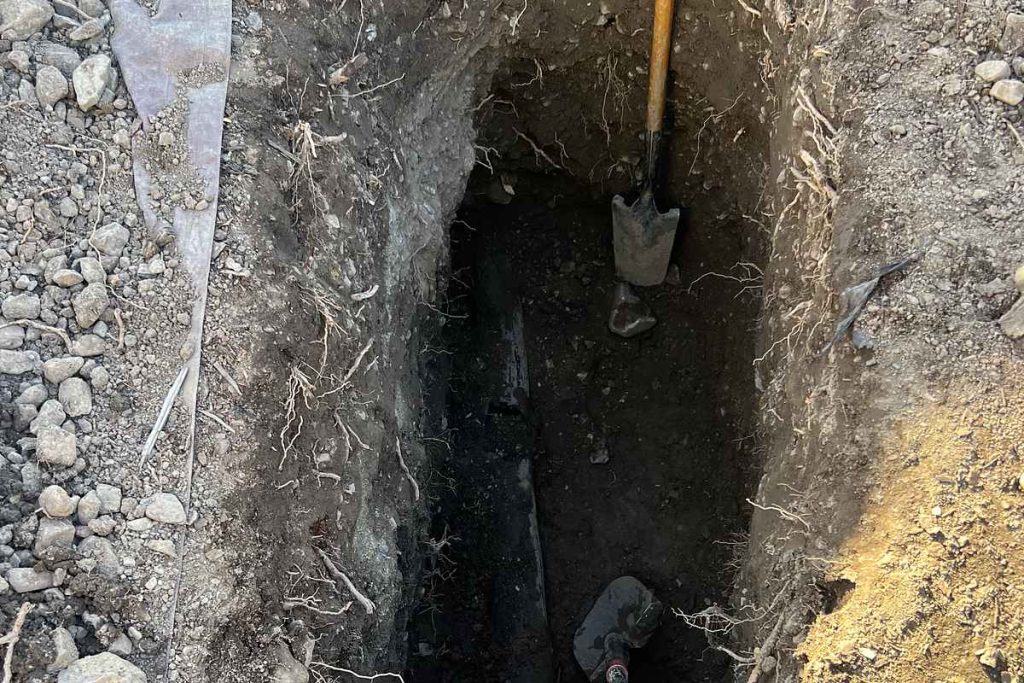 Deep excavation dug by hand to reach the sewer line