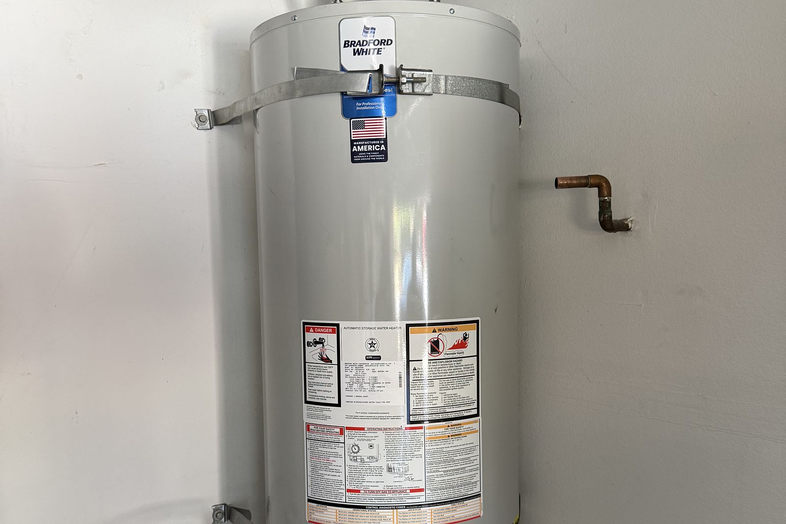 New water heater set on a platform in a closet