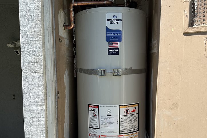 New Bradford White water heater installed in a hallway closet