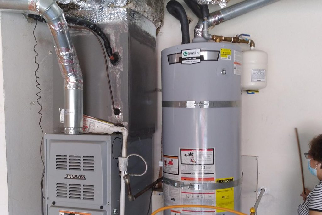 Water heater and furnace installed side by side in a closet
