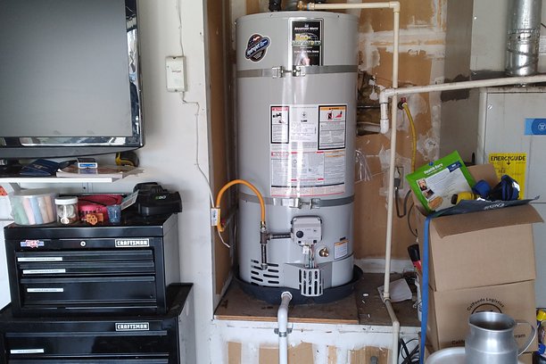 Water heater with new venting in a garage corner