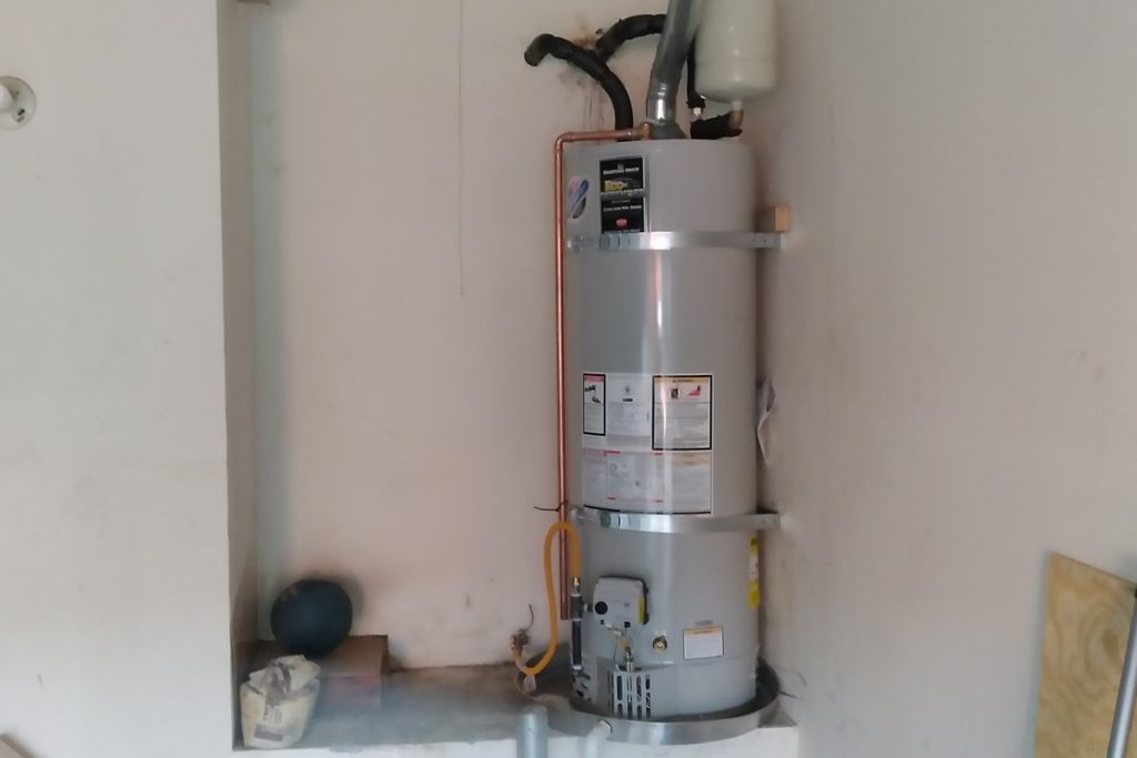 Water heater and vent pipe in a clean white closet