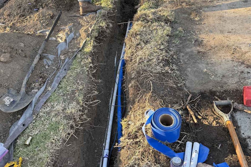 Technician digging the trench for a new water service